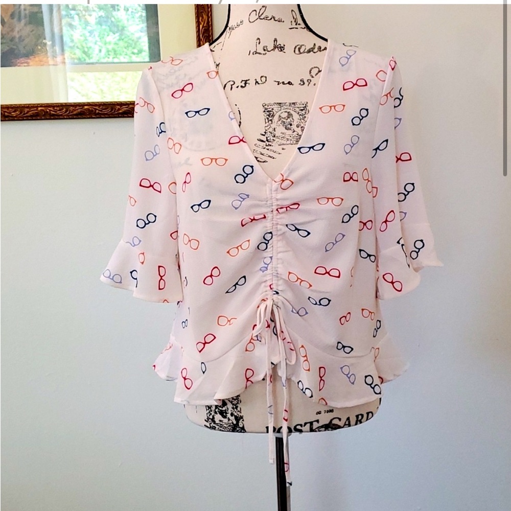 Elodie glasses print cropped and ruffled top.